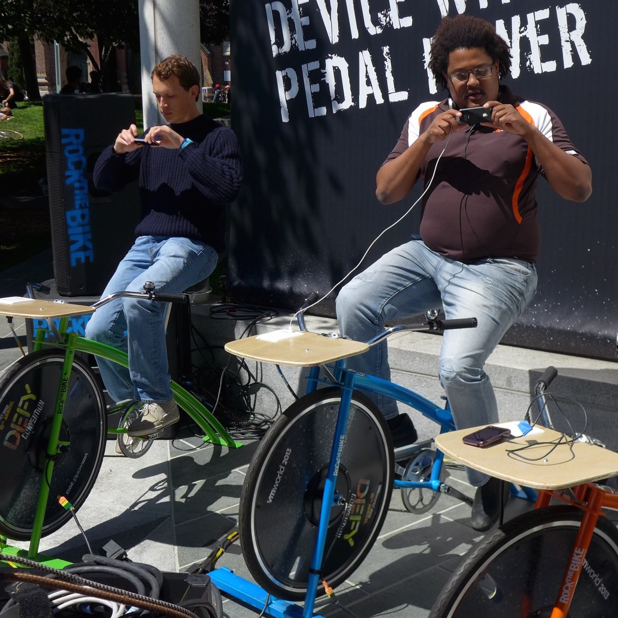 Attendees charging devices on the pedal-powered station